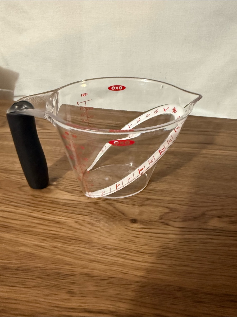Oxo Clear Plastic Measuring Cup with Black Handle and Red Markings